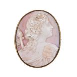 A 19th century conch shell cameo, the oval cameo carved with a bacchante, within a gold setting, 4.