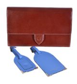 Aspinal of London, a red leather travel document case, the single flap with button clasp, opening to