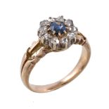 A sapphire and diamond cluster ring, the central circular cut sapphire claw set within a surround of