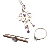 An Edwardian amethyst and seed pearl pendant, the scrolling openwork panel set with circular cut