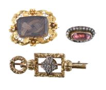 A Victorian hairwork brooch, the rectangular glazed panel with plaited hair beneath, within a