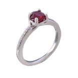 A ruby and diamond ring, the oval cut ruby claw set between brilliant cut diamond set shoulders,