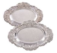 A pair of Edwardian silver pierced and embossed shaped oval baskets by Harrison Brothers & Howson,