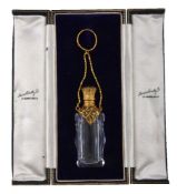 A gilt metal mounted cut glass scent bottle, late 19th century, scroll foliate engraved and pierced,