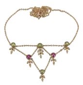 An Edwardian peridot, pink tourmaline and seed pearl necklace, circa 1910, the front section set