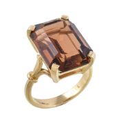 An 18 carat gold citrine ring, the rectangular cut citrine in a four claw setting, to the polished