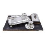 A silver shaped rectangular ink stand by Charles Stuart Harris, London 1920, with two pen trays, two