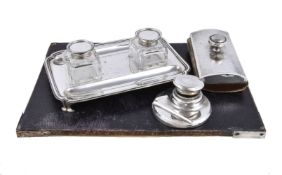 A silver shaped rectangular ink stand by Charles Stuart Harris, London 1920, with two pen trays, two