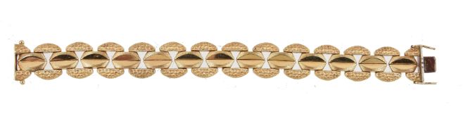 A 1970s gold coloured bracelet, composed of textured links, to a concealed clasp, stamped 750 with