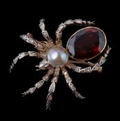 A garnet and diamond spider brooch, the body set with an oval cut garnet and a mabé pearl, the