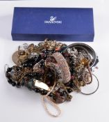 A quantity of costume jewellery, including: brooches; necklaces; and other items