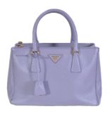 Prada, Saffiano, a lilac leather handbag, with twin loop handles, the satin interior with two