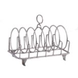 A George III silver toast rack by William Abdy II, London 1804, with a loop handle over the six