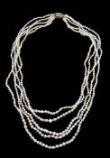 A five strand natural pearl necklace, the graduated pearls with seed pearl spacers, to a gold backed