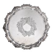 A silver shaped circular salver by James Deakin & Sons, Sheffield 1925, with a raised scroll and