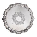 A silver shaped circular salver by James Deakin & Sons, Sheffield 1925, with a raised scroll and