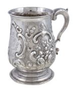 A George III baluster mug by James Stamp, London 1778, with a leaf capped double scroll handle,