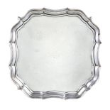 A silver shaped square salver by Barker Brothers, Chester 1922, with a raised moulded border,