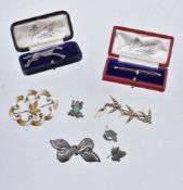 A small selection of jewellery, including: an early 20th century Canadian silver and enamel brooch