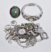 A collection of silver coloured costume jewellery, to include a hinged bangle set with oval cut