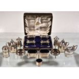 A collection of silver cruet items, mainly 20th century, including: a set of four oblong baluster