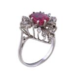 A pink doublet stone and diamond ring, the oval cut pink doublet stone, claw set within a surround