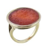 A 19th century carnelian ring, the oval carnelian panel carved with an armorial, in a collet