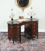 A Victorian mahogany kidney shaped desk, circa 1890, the shaped top with moulded edge and gilt