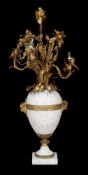 A French gilt metal mounted white marble six light table candelabrum modelled as a vase of