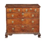 A George II walnut and feather banded chest of drawers,circa 1735, the quarter veneered and cross