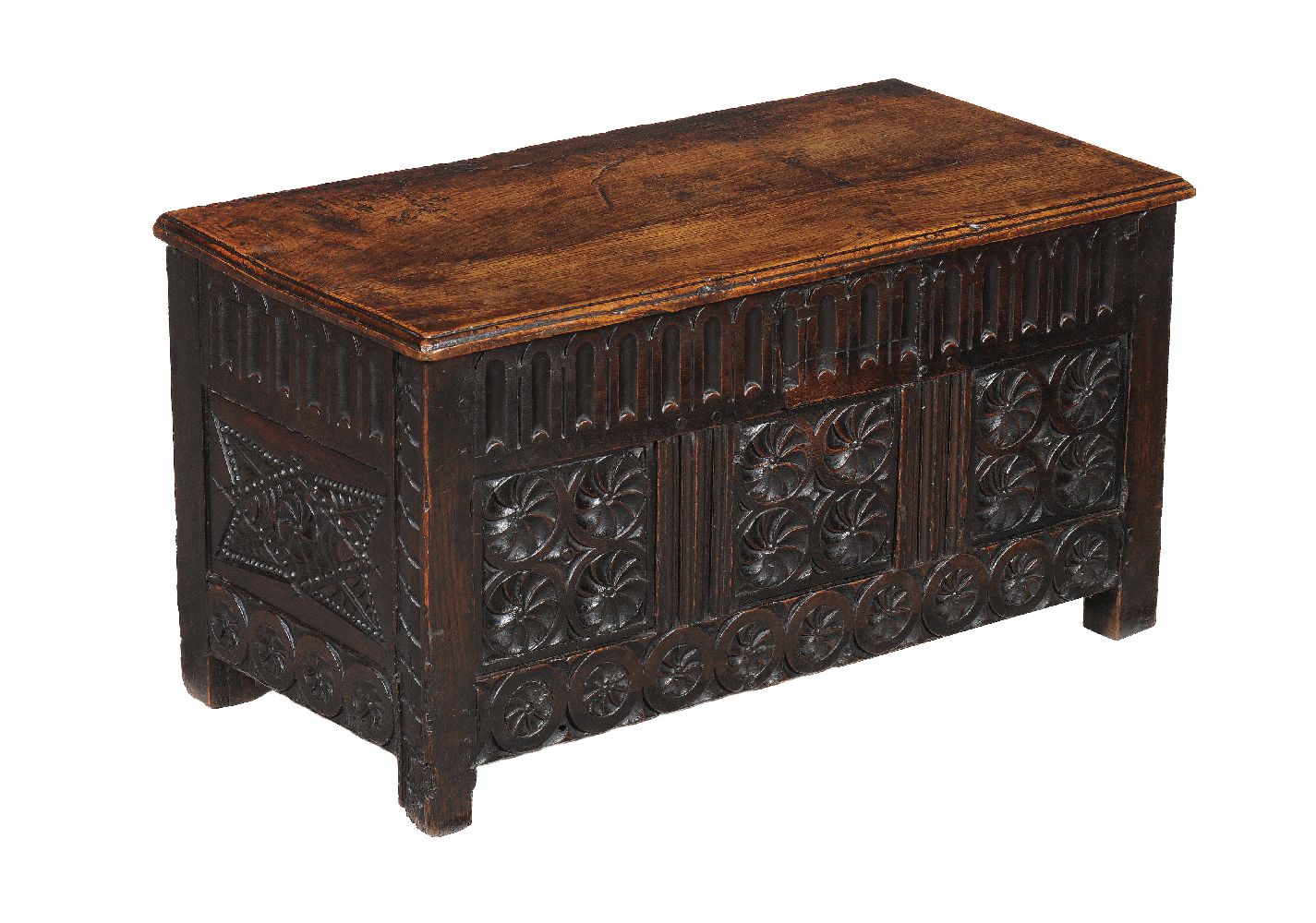 A Charles II panelled oak chest, circa 1660, of small proportions, the hinged lid above the fluted