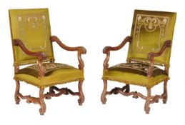 A pair of walnut and upholstered armchairs in Louis XIV style, late 19th/early 20th century, the