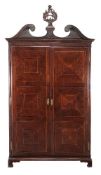 A George III mahogany press cupboard, circa 1770, the swan neck pediment incorporating carved