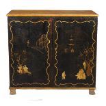 A Regency black lacquer and gilt Chinoiserie decorated clothes press, circa 1815, the simulated