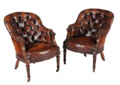 A pair of late Victorian carved walnut and button leather upholstered armchairs, circa 1890, each