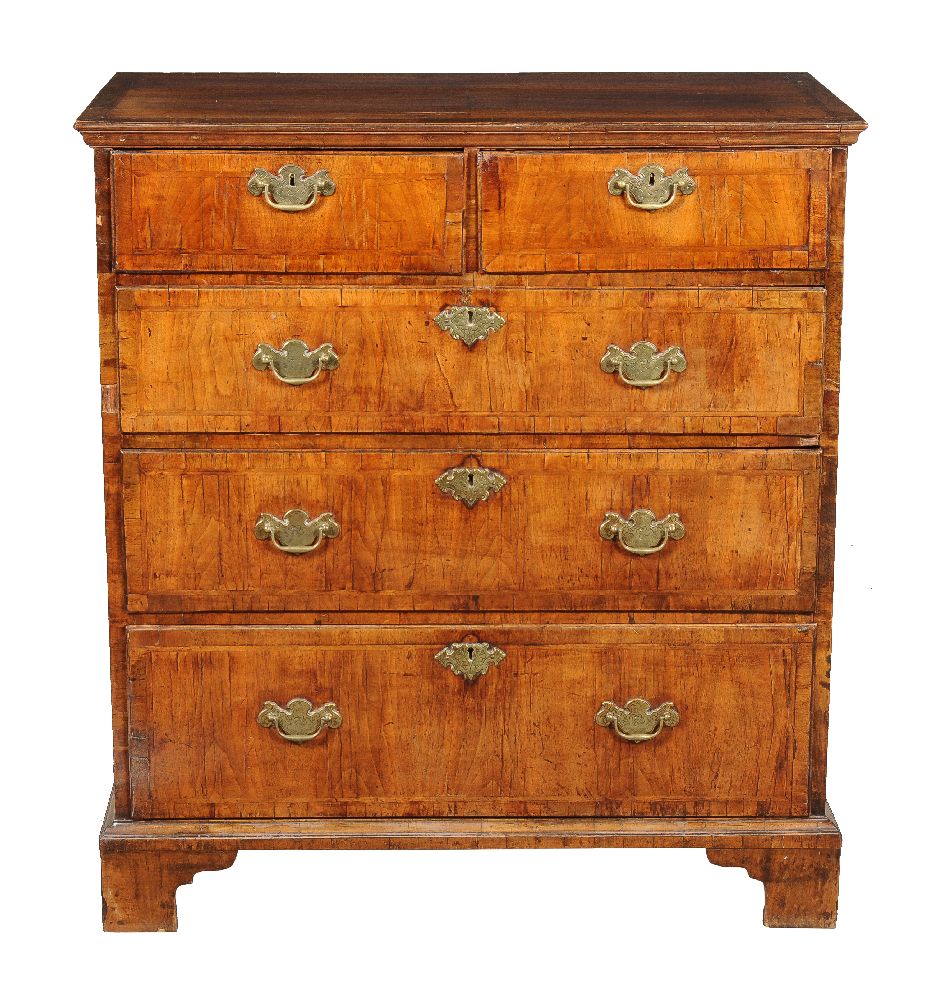 A George I walnut and feather banded chest of drawers, circa 1720, the feather and cross banded