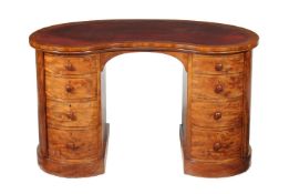 A Victorian mahogany kidney shaped desk by HOLLAND & SONS, circa 1860, the shaped top with tooled