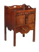 A George III mahogany tray top night commode, circa 1780, the rectangular top with shaped and