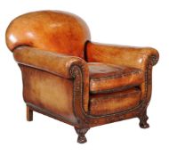 A pair of carved mahogany and leather upholstered armchairs, circa 1930, the padded back and loose