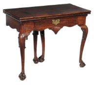 A George II Irish mahogany folding tea table, circa 1750, the folding rectangular top with moulded