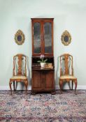 A George I walnut bureau bookcase, circa 1720, the moulded cornice above a pair of mirror panelled