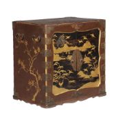 A Japanese lacquer and gilt decorated table cabinet, Meiji period, the pair of panelled doors with
