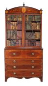 A George III mahogany and marquetry decorated secretaire bookcase, circa 1790, the arched cornice