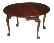 A George II mahogany drop leaf dining table, circa 1750, the oval top incorporating two hinged