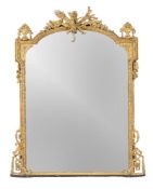 A carved giltwood and composition wall mirror, second half 19th century, the arch shaped plate