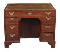 A George III mahogany double sided knee hole desk, circa 1780, the tooled leather inset writing