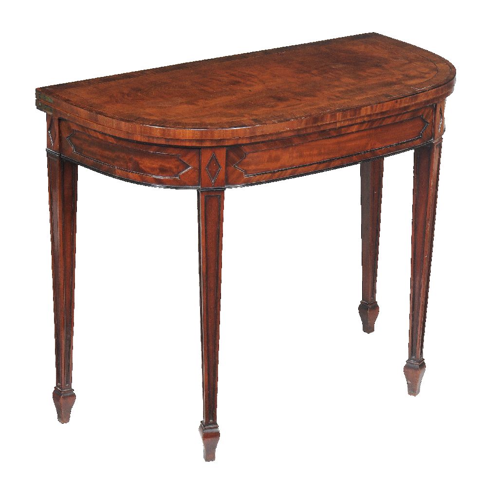 A pair of George III mahogany card tables, circa 1780, each D shaped hinged top opening to a baize