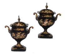 A pair of Regency painted and parcel gilt toleware pedestal urns and covers, circa 1815, decorated