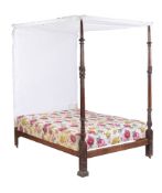 A George III mahogany four post bed, circa 1780, the fabric covered canopy and sectional carved wood