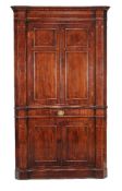 A George III mahogany and inlaid standing corner cupboard, circa 1790, the moulded an chequer banded